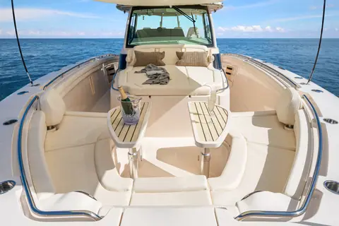 Bow lounge of the Grady-White Canyon 456 with folding tables and the console windshield ahead