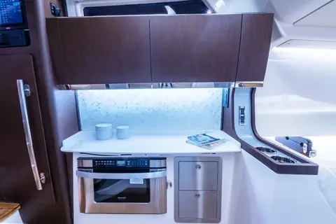 Galley inside the console cabin of the Grady-White Canyon 456 with microwave and cabinets