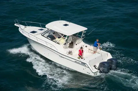 Grady-White Express 330 running seen from above with anglers in the cockpit and twin outboards