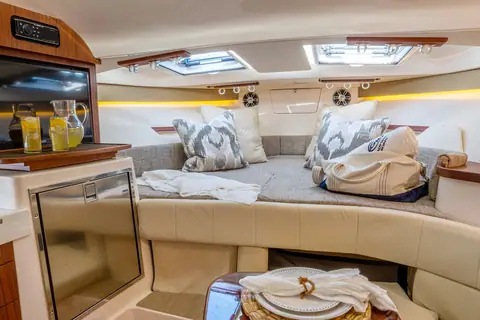 Cabin of the Grady-White Express 330 with dinette berth, galley and overhead hatches