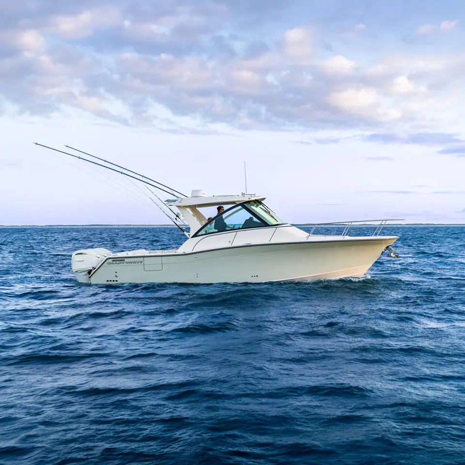 Grady-White Express 340 underway in profile with outriggers raised