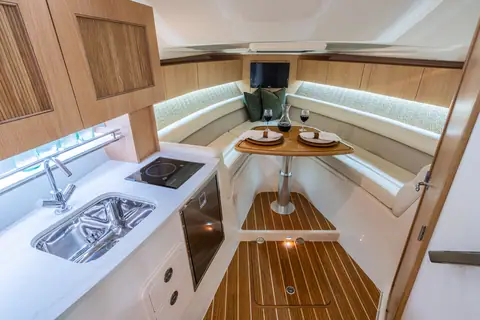 Cabin of the Grady-White Express 340 with galley, teak sole and dinette forward