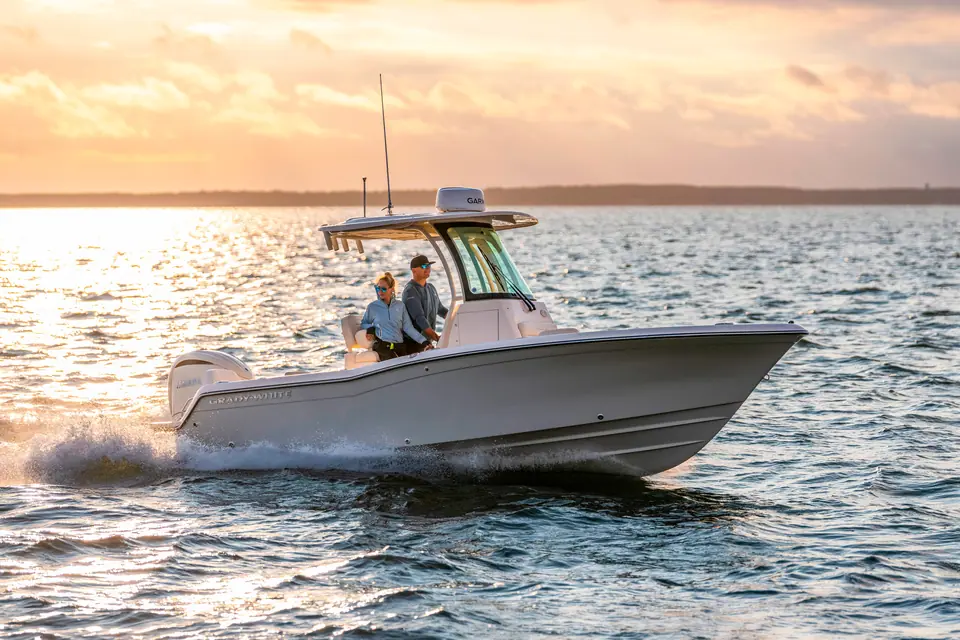 Grady-White Fisherman 216 cruising at sunset with two people at the helm