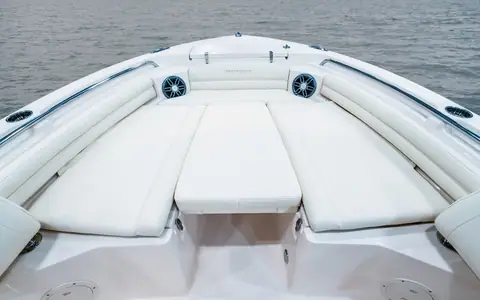 Bow seating of the Grady-White Fisherman 216 with cushioned lounges and filler cushion