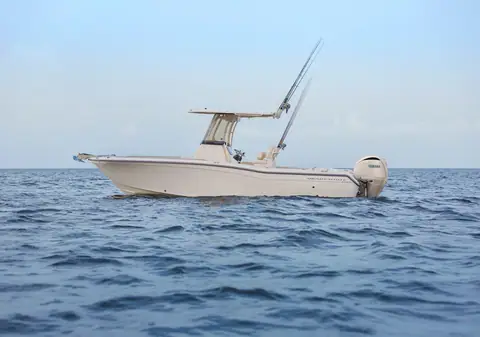 Grady-White Fisherman 257 at rest in profile with its T top and outriggers