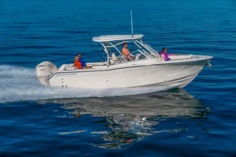 Grady-White Freedom 275 dual console running on blue water with twin outboards