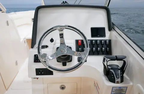 Helm of the Grady-White Freedom 275 with stainless wheel, display and controls