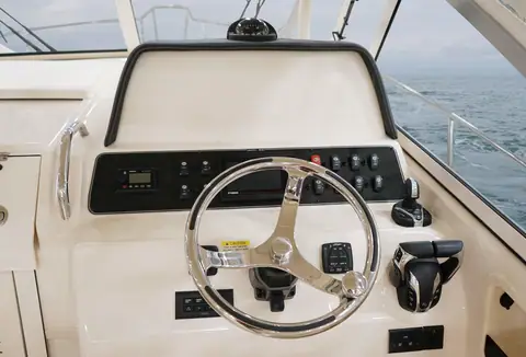 Helm of the Grady-White Marlin 300 with stainless wheel and switch panel