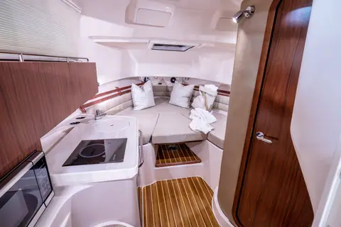 Cabin of the Grady-White Marlin 300 with galley, dinette berth and teak sole