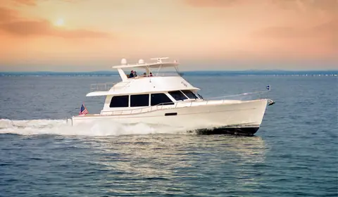 Grand Banks 60 flybridge running at speed at sunset