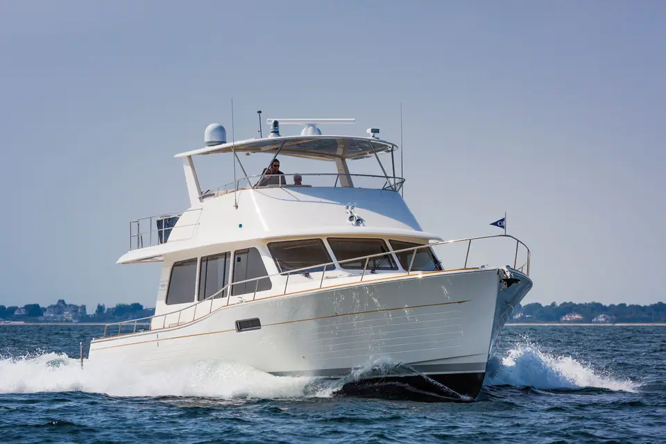 Grand Banks 60 flybridge cruising with a bow wave