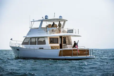 Grand Banks 60 seen from the stern quarter showing the teak cockpit, aft deck and flybridge