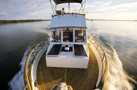View aft from the bow of a Grand Banks 32 underway over the teak foredeck and flybridge