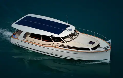 Elevated view of the Greenline 33 underway showing the solar panel roof and teak side decks