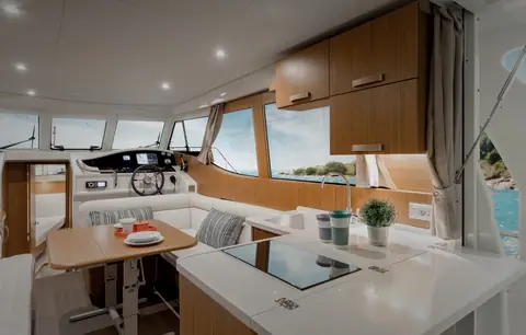 Greenline 33 saloon with the galley, dinette and lower helm under wide side windows