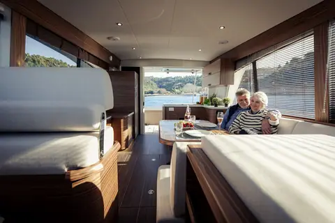 Greenline 40 main salon with wood trim, a dinette and the galley aft by the cockpit doors