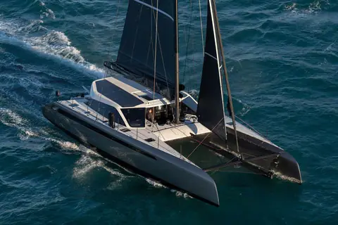 Aerial view of the Gunboat 68 catamaran sailing upwind with its dark hulls and solar roof