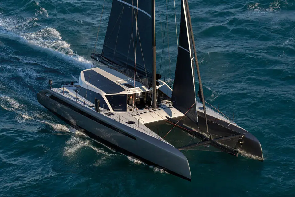 Aerial view of the Gunboat 68 catamaran sailing upwind with its dark hulls and solar roof