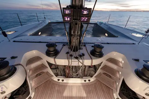 Gunboat 68 forward cockpit with winches, mast instruments and the teak sole at dusk