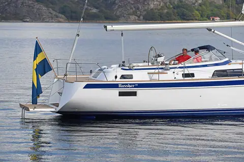 Stern quarter of a Hallberg-Rassy 44 at anchor showing the bathing platform and windscreen