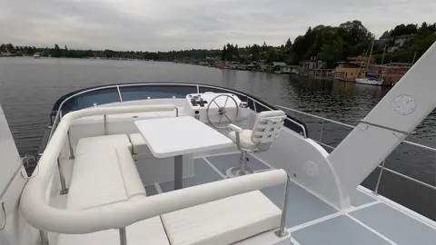 Helmsman 43E Pilothouse flybridge with a white settee, table and helm seat
