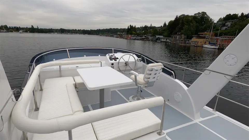 Helmsman 43E Pilothouse flybridge with a white settee, table and helm seat