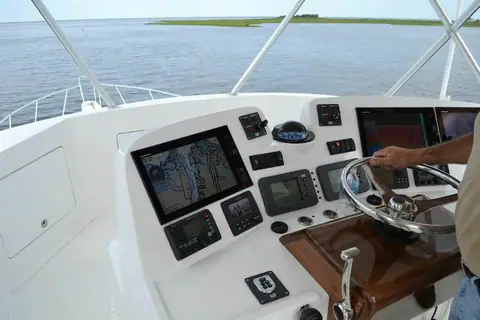 Henriques 50 Sportfisherman flybridge helm with electronics, a stainless wheel and teak trim