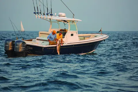 Anglers fishing from the cockpit of a Hunt 32 Center Console with 32CC on the hull