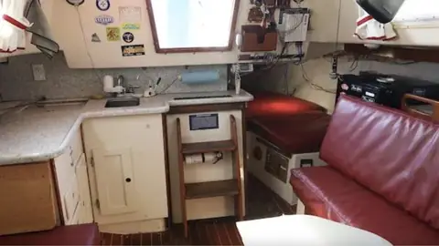 Hunter 30 galley and companionway steps beside the red saloon settee
