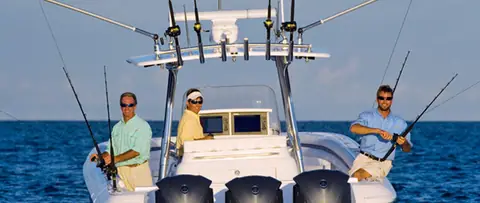 Anglers fishing from the cockpit of an Intrepid 400 Center Console beside the helm and T top