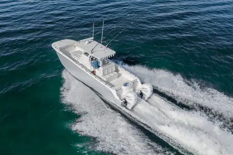 Aerial view of the Invincible 33 Catamaran at speed showing its center console layout