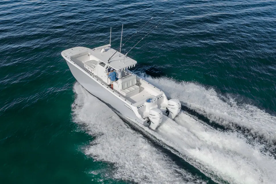 Aerial view of the Invincible 33 Catamaran at speed showing its center console layout