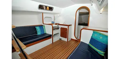 J/105 main cabin with settee berths, teak sole and the forward cabin door