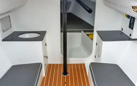 J/88 cabin with settee berths, a sink, keel stepped mast and teak sole