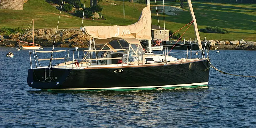 J/100 on a mooring with sails furled and the J/100 logo on the sail cover