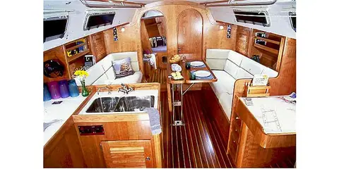 J/120 main saloon with cherry joinery, U shaped settee and galley
