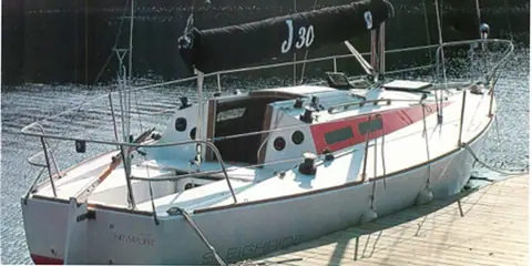 J/30 deck and cockpit seen from the dock with the mainsail covered
