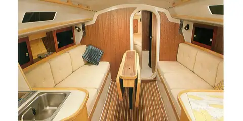 J/30 main cabin with settees, a drop leaf table and the forward cabin