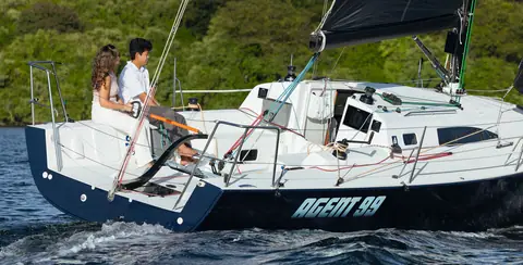 J/99 open cockpit and transom seen from astern with two people at the tiller