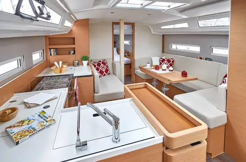 Jeanneau Sun Odyssey 410 saloon with galley in the foreground and the dinette forward