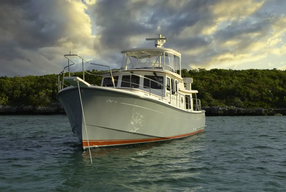 Krogen Express 52 at anchor under a dramatic sky, seen from the bow with its flybridge