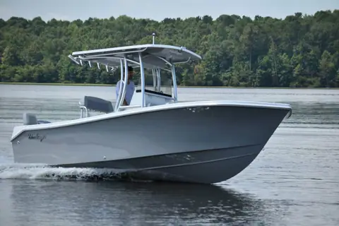 KenCraft 21 seen from the bow quarter cruising with its flared bow and T top