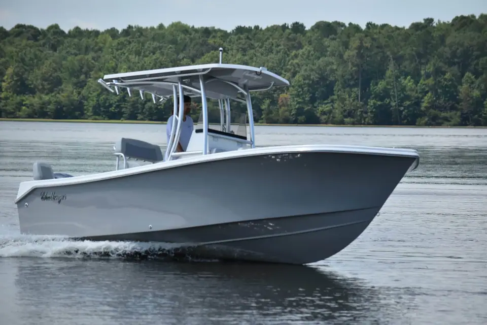 KenCraft 21 seen from the bow quarter cruising with its flared bow and T top