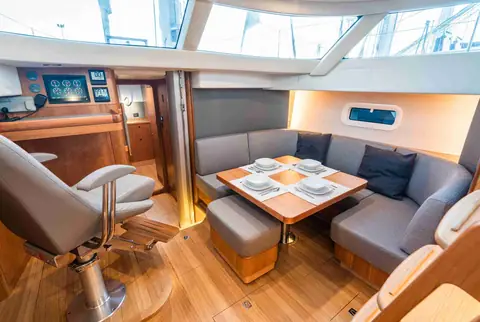 Kraken 50 saloon with a gray dinette, wood joinery and the navigation station