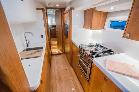 Kraken 50 galley with a stove and oven, a sink and white counters