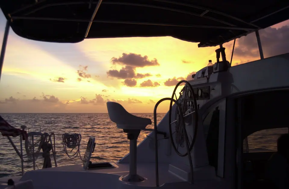 Helm and cockpit of a Lagoon 380 catamaran at sunset