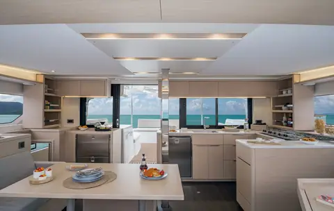 Lagoon 46 saloon with the galley and panoramic forward windows