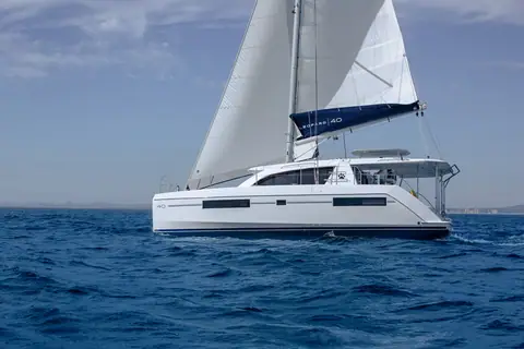 Leopard 40 sailing in profile showing its hull windows, hardtop and full sail plan