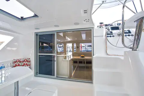 Leopard 44 aft cockpit with dining table, helm steps and sliding door to the saloon