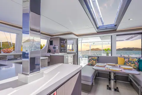 Leopard 45 saloon with galley counter, dinette and open doors to the cockpit